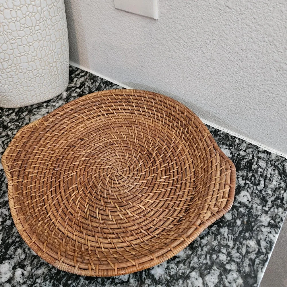 hand-woven rattan tray with a distinct spiral patterns serving plate